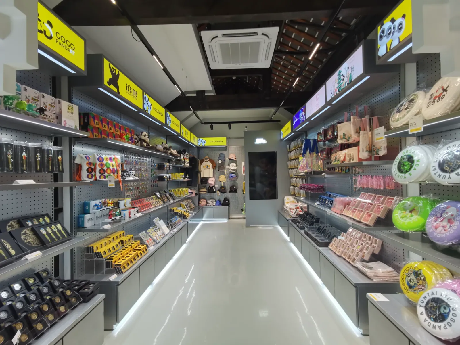 A whole store fitted with pegboard wall bays, light-box headers and lit base cabinets