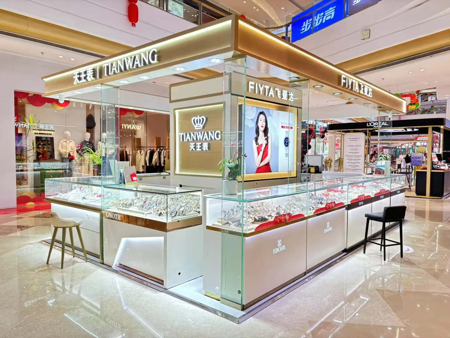 Glass watch display counters with a gold-tone overhead frame